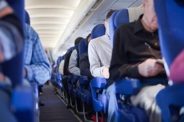 Some air travelers use noise reducing headphones to dampen the roar of the plane's engines.
